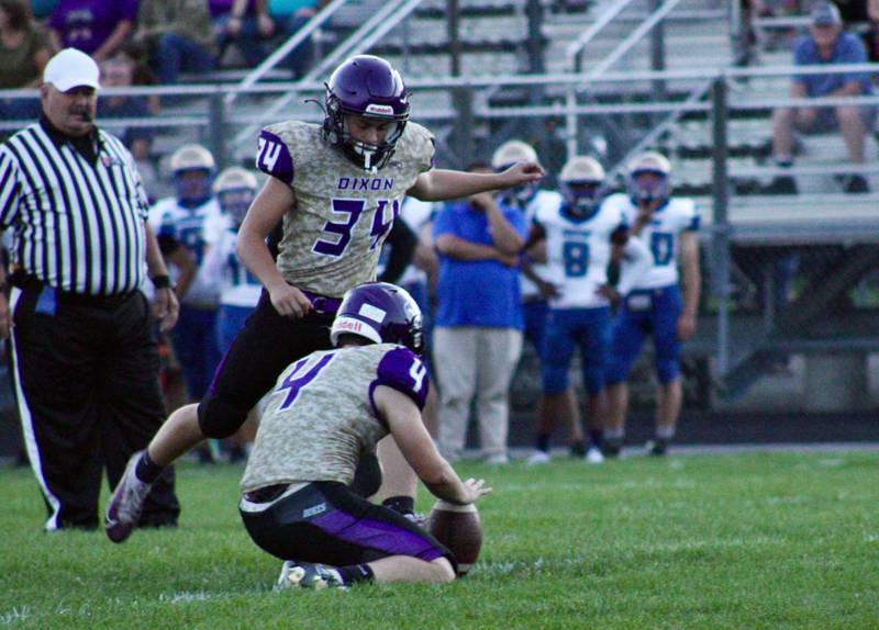 Kicker Caleb Carlson (34) kicks an extra point with placeholder Easton Roux (4) for Dixon.