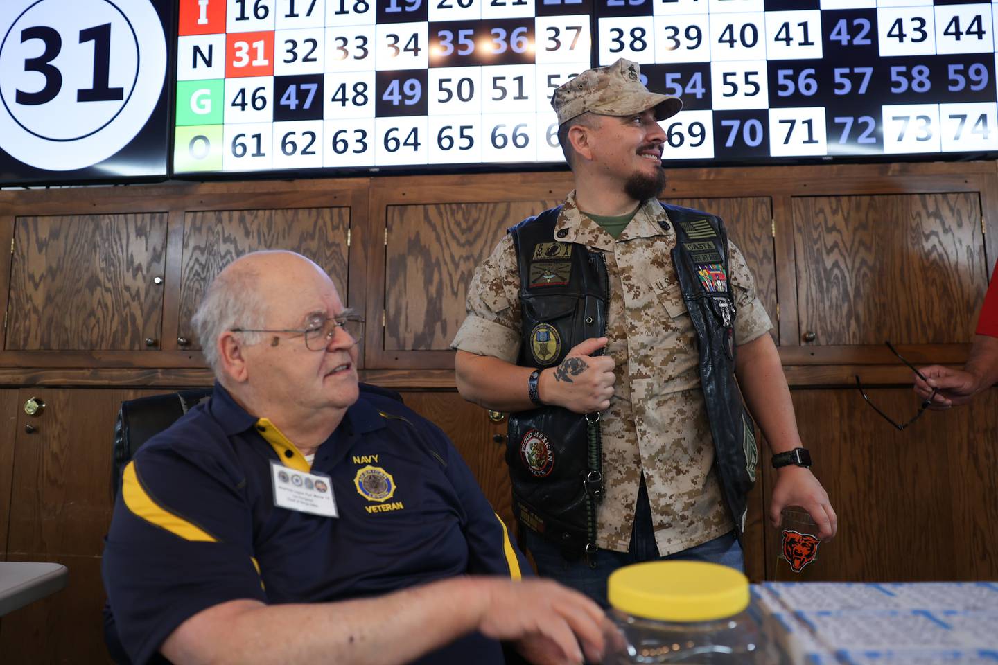 American Legion Marne Post 13 commander James Castaneda, right, a Marine veteran, checks in with Lee Perignon, a Navy veteran and American Legion member for 48 years, as they get ready for BINGO night.