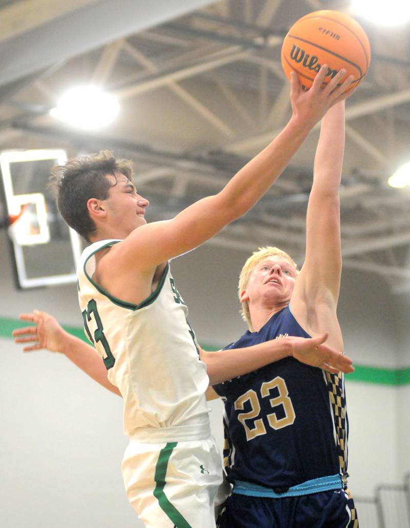 Seneca senior forward Brady Sheedy shoots as Marquette sophomore forward Luke McCullough defends on Friday, Dec. 5, 2025 at Seneca High School.