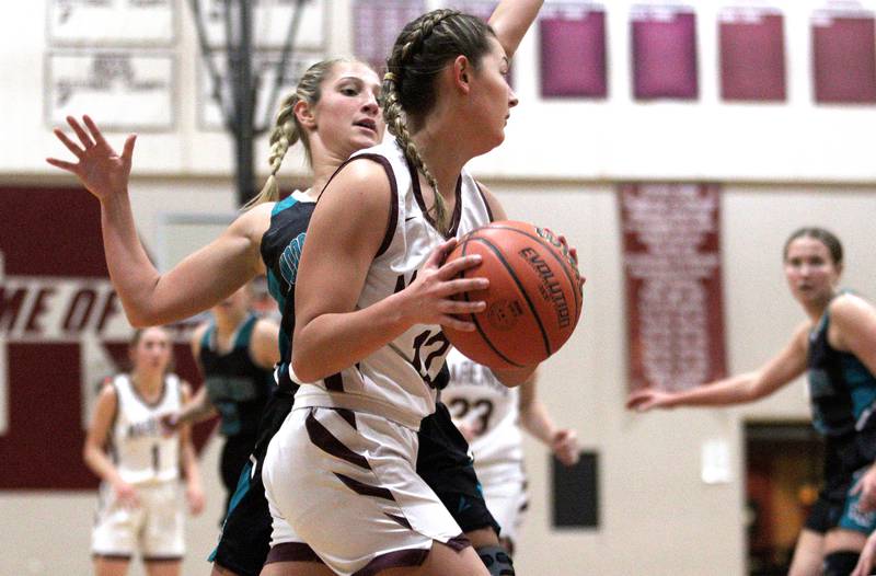 Marengo’s Gabby Gieseke looks for an option under the hoop against Woodstock North in varsity girls basketball at Marengo Tuesday evening.