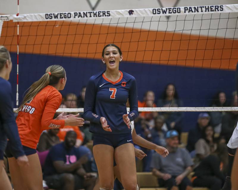 Oswego's Hannah Herrick (7) celebrates a kill with teammates during volleyball match between Romeoville at Oswego. Oct 16, 2025.