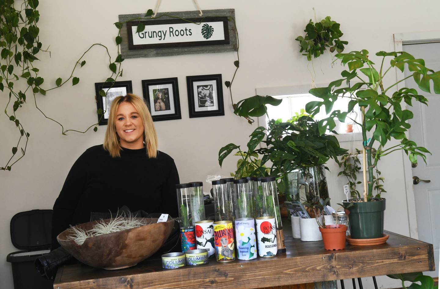 Ashley Ruch stands at the counter of her new business Grungy Roots in Grand Detour.