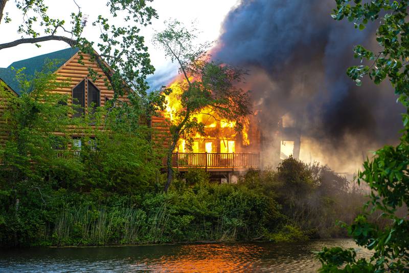 A cabin unit is engulfed in flames Monday, May 30, 2022, at Grand Bear Resort in Utica.