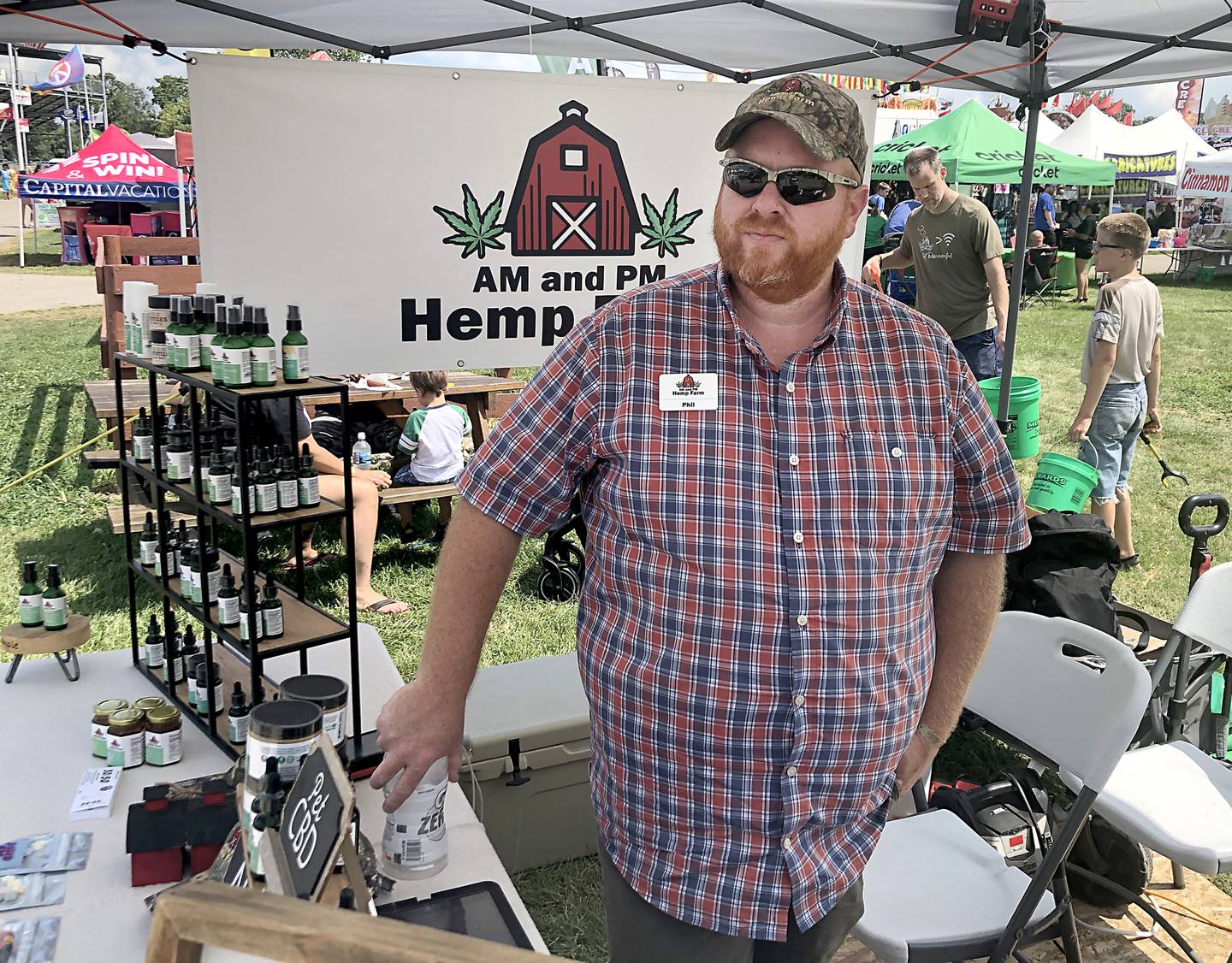 Phil Montgomery of Kirkland is one of the farmers in northern Illinois who planted hemp after its legalization in 2018. Seen here at the McHenry County Fair on Aug. 6, 2022, Montgomery has quit his day job outside of the farm to run your hemp AM and PM.  Farm, making CBD infused products.