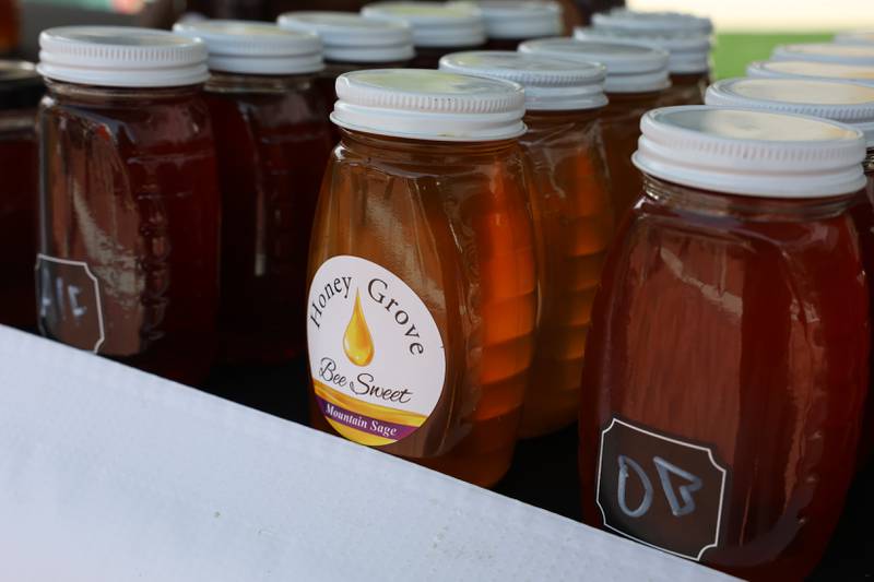 Jars of home made honey sits on display at the Honey Grove tent at the new city square for the farmers market on Friday, May 22, 2026 in Joliet.