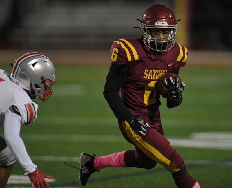 Schaumburg’s Omarion Jones looks for running room against Palatine in a football game in Schaumburg on Friday, October 14, 2022.