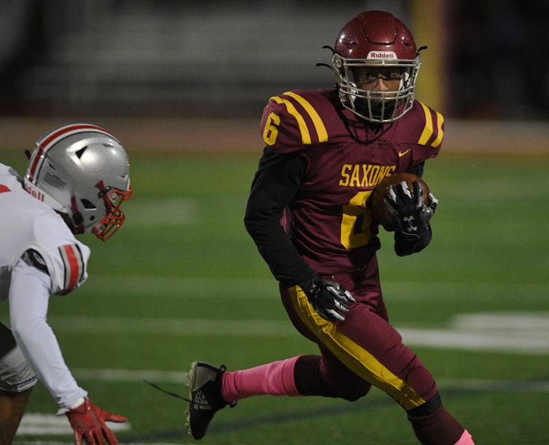 Schaumburg’s Omarion Jones looks for running room against Palatine in a football game in Schaumburg on Friday, October 14, 2022.
