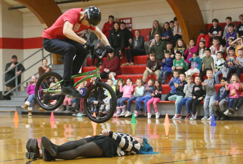 Matt Wilhelm, a national BMX Rider, Guinness World Record holder and America’s Got Talent semi-finalist hurdles staff members Mrs. Anna Dempsey and Mrs. Amber Zrust during an assembly on Monday, Jan. 13, 2024 at Ladd Grade School. Wilhelm, a three-time X Games medalist and two-time national champion, is a native to Oak Lawn. Wilhelm was bullied as a child. Today, he presents a strong message while speaking to children while focusing on kindness, positivity and the differences that one person can make.