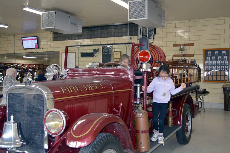 Kamri Velez, 7, climbs off an antique Polo Fire Protection District firetruck while sister Kynsley Velez, 5, stays behind the wheel. The girls played on the firetruck during the Polo Fire Protection District's annual spring breakfast fundraiser on April 30, 2023. A total of 479 people were served, and $4,202.17 raised to go toward the purchase of new equipment for the fire district.