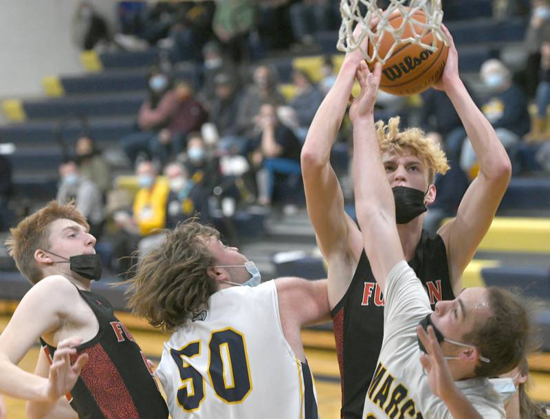 Fulton's Baylen Damhoff grabs a rebound and shoots during  Jan. 14 action against Polo.