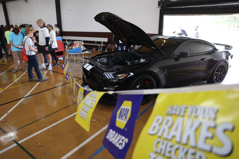 NAPA set up a table which included a Ford Mustang at the Grundy Area Vocational Center 8th grade Career Fair at Morris High School on Tuesday, Oct. 29, 2024 in Morris
