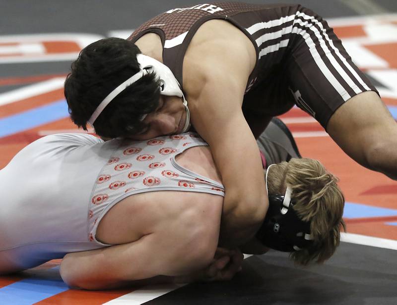Joliet Catholic's Elias Gonzalez tries to turn Marian Central's Noah Cerny in their 144-pound match during a triangle wrestling meet on Saturday Jan. 11, 2025, between Marian Central, Joliet Catholic, and Mt. Carmel at Marian Central High School in Woodstock.