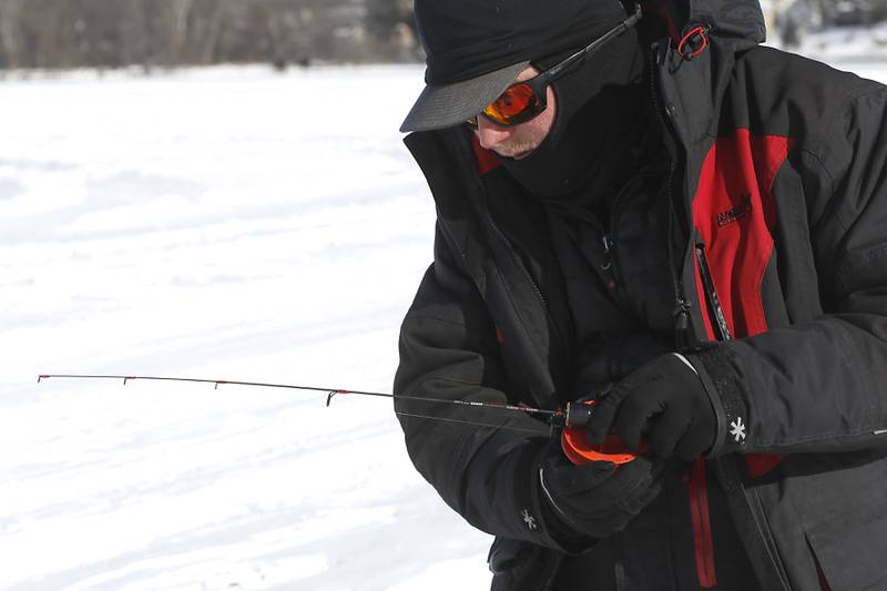 Trevor Janes, who owns Wet N Wild Outfitters, ice fishes Friday, Feb 3. 2023, on Petite Lake near Fox Lake.