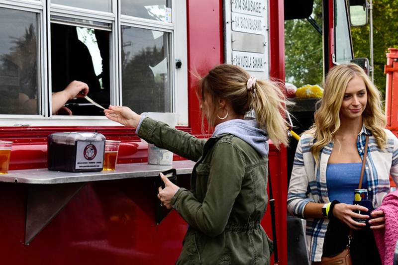 Christina Polcyn and Maddie Bayliss, right, line up for one of the many food truck vendors at the RISE Up music festival on Saturday, Sept. 25, 2021, at Petersen Park in McHenry.  Funds raised from the Friday and Saturday music festival, which included Sugar Ray, Smash Mouth and Brantley Gilbert, are going toward a new splash pad at Fort McHenry, according to the RISE Up Foundation's website.