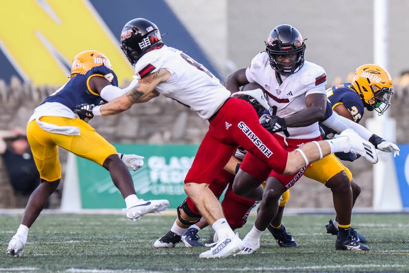 NIU running back Antario Brown looks for a hole in the Toledo line in the Huskies' 35-33 loss on Saturday, Sept. 30, 2023 at the Glass Bowl.