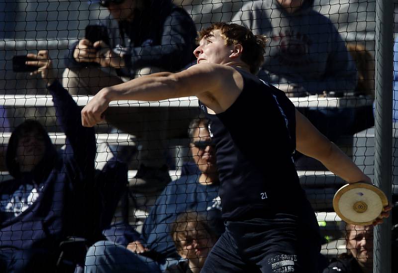 Cary-Grove’s Zachary Petko throws the discus as he competes Thursday, April 21, 2022, during the McHenry County Track and Field Meet at Richmond-Burton High School.