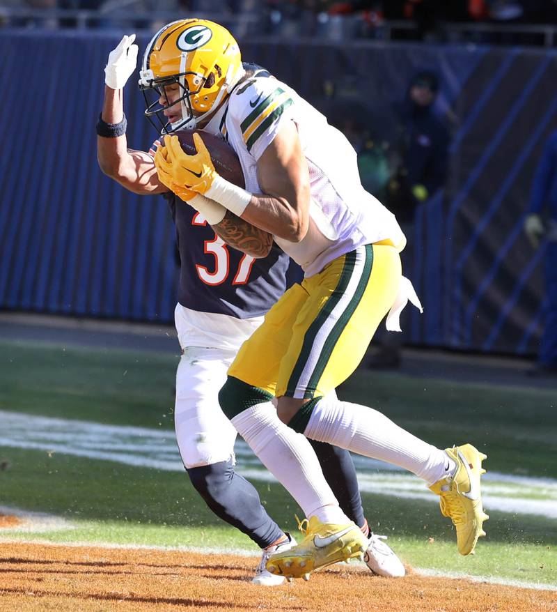 Green Bay Packers wide receiver Christian Watson catches a touchdown in front of Chicago Bears safety Elijah Hicks during their game Sunday, Dec. 4, 2022, at Soldier Field in Chicago.
