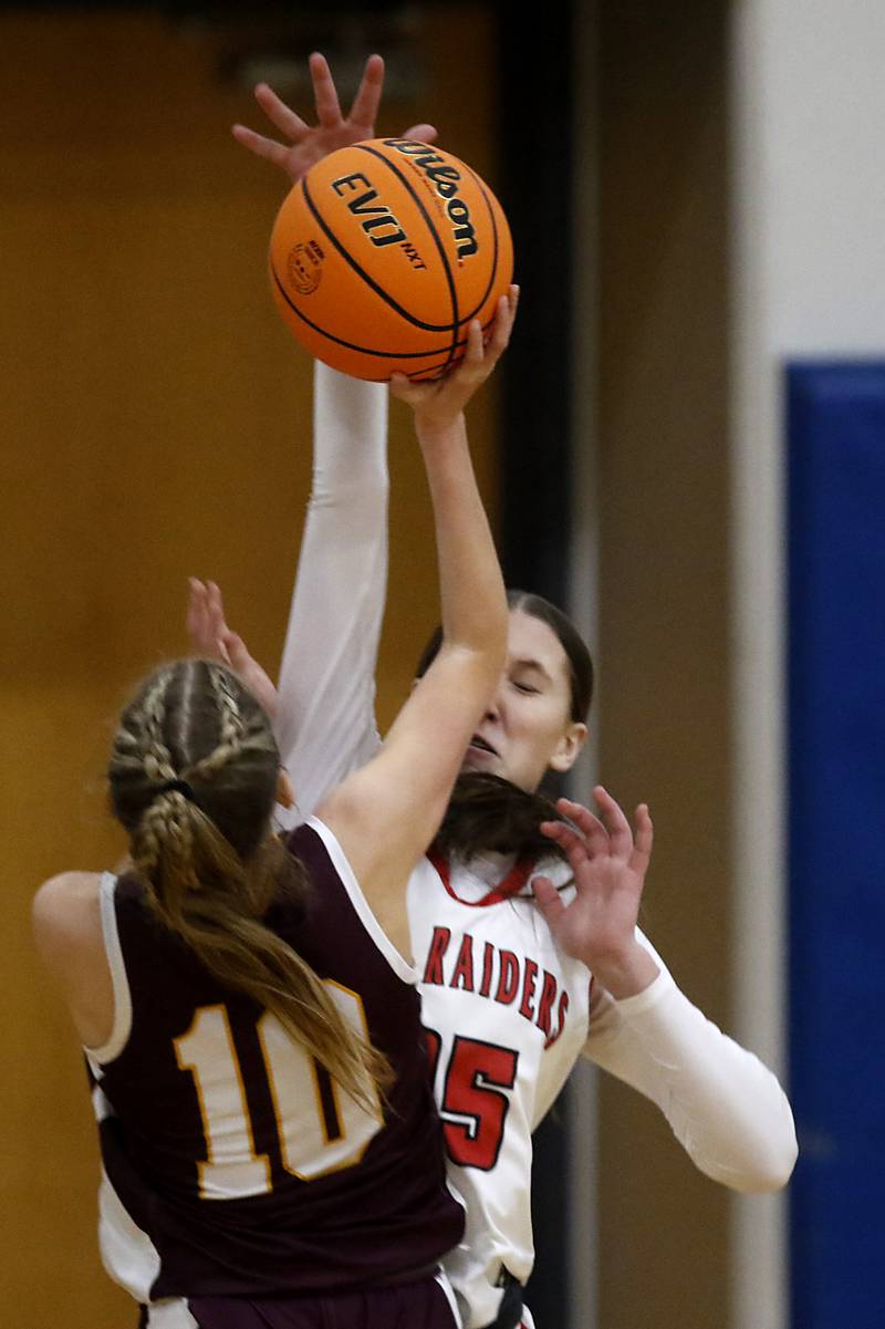 Huntley's Evie Freundt books the shot of Loyola Academy's Clare Weasler during the IHSA Class 4A Gurnee Warren Supersectional girls basketball game on Monday, March 3, 2025, at Warren Township High School in Gurnee.