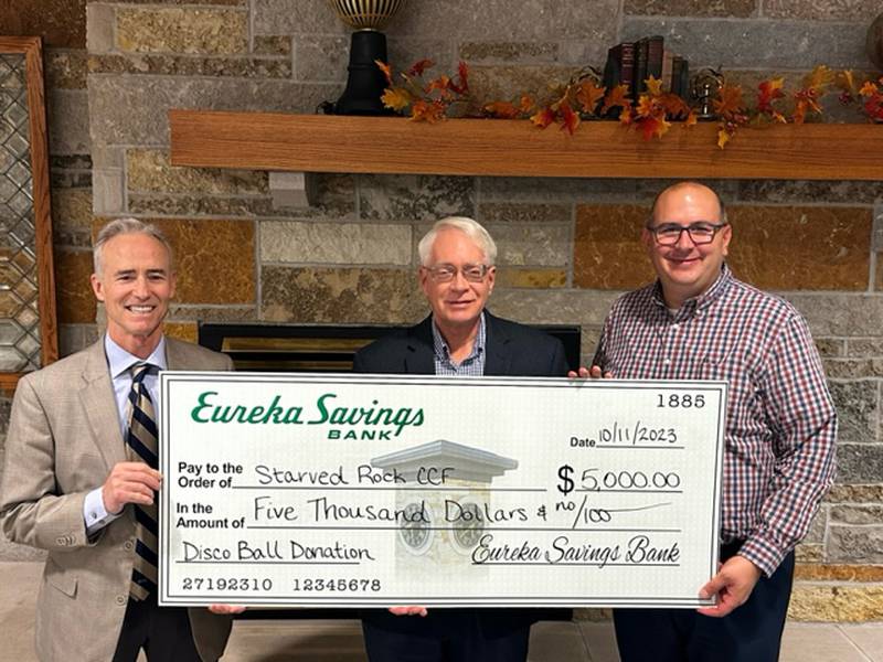 Starved Rock Country Community Foundation CEO Fran Brolley (left) and Board Chair Reed Wilson, met recently with Eureka Savings Bank President John McCormick to receive a $5,000 check for the Foundation’s Nov. 4 Disco Ball.