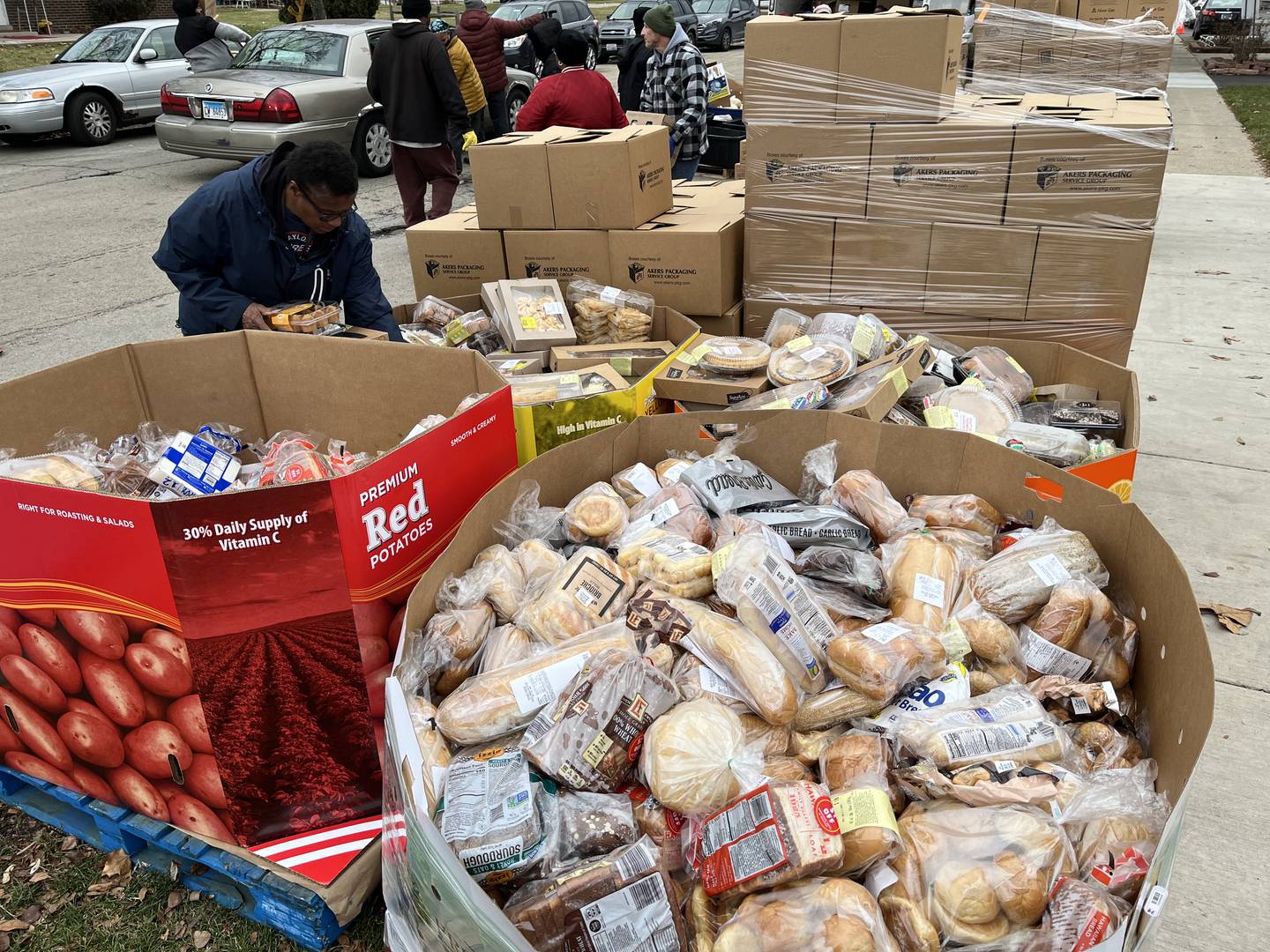 Volunteers sort through food for a food pantry event on Thursday, Dec. 21, near Second Baptist Church in Joliet.