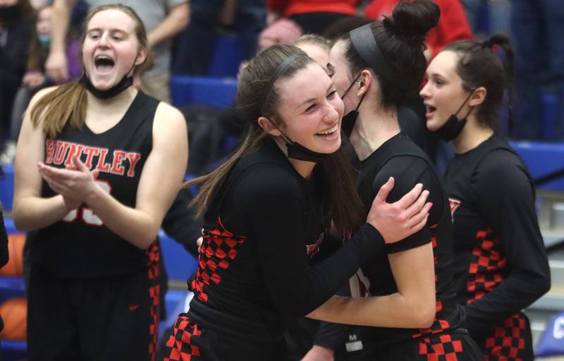 From left, Huntley’s Mallory Winters, Samantha Campanelli,  Jessica Ozzauto, and Ashlyn Horton celebrate a Red Raider win in varsity girls basketball at Burlington Central Monday night.