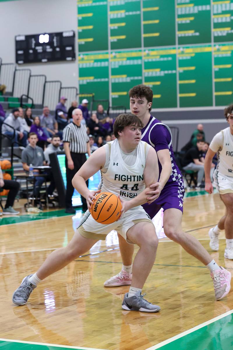 Bishop McNamara's Cale Hamilton drives to the lane Wilmington's Declan Moran during Bishop McNamara's 61-24 victory over Wilmington in the IHSA Class 2A Seneca Sectional semifinal on Tuesday, March 3, 2026.