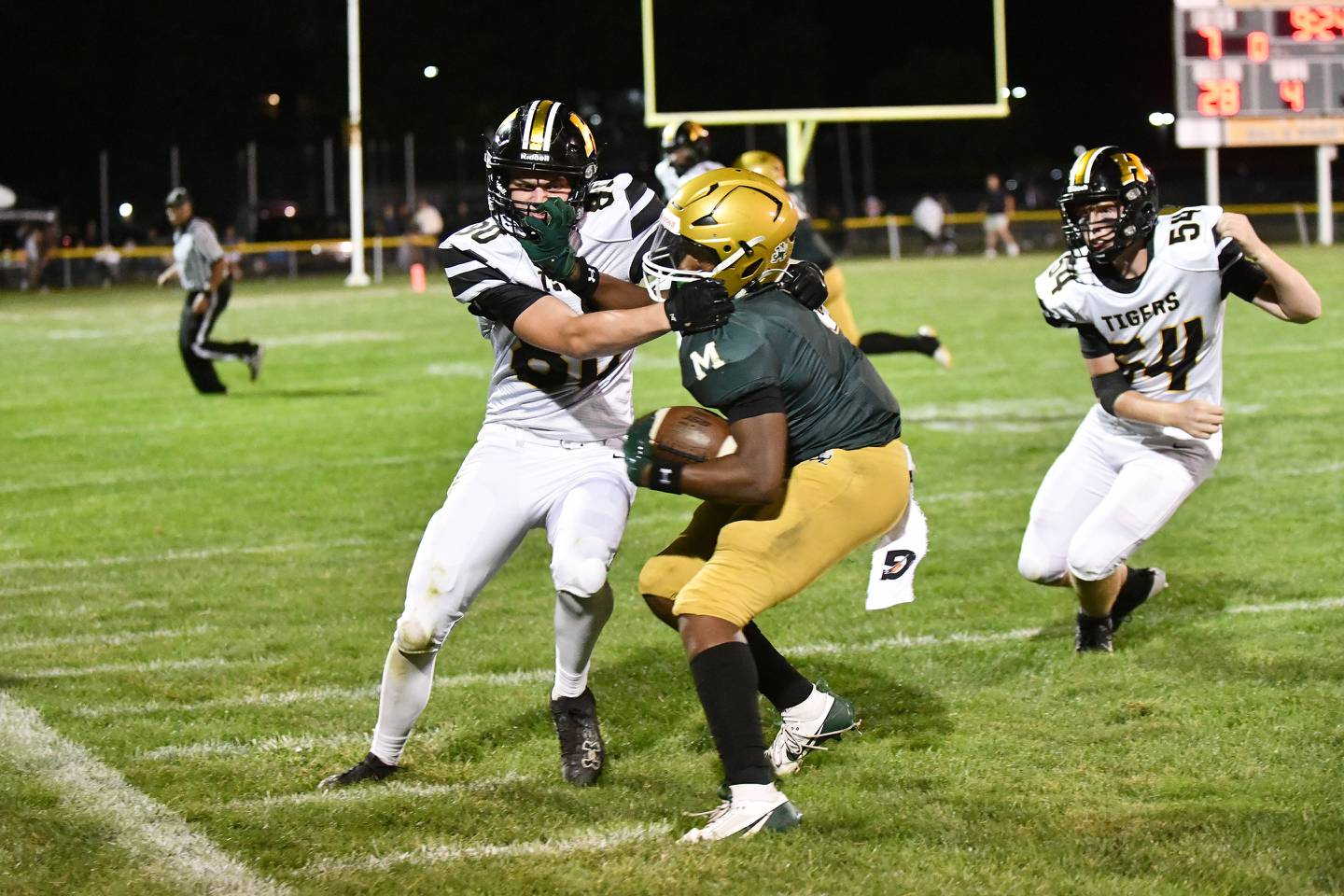 Bishop McNamara's Julius May tries to fend off Herscher's Reed Laird on Friday, Sept. 6, 2024, during the Fightin' Irish's 20-13 loss to Herscher.