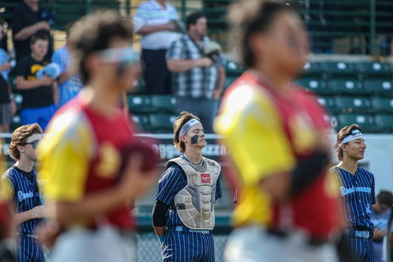 Nazareth's Jaden Fauske (21) stands during the playing of the National Anthem before their Class 3A Crestwood Supersectional game between vs Lindblom.  June 5, 2023.