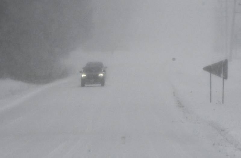 Vehicles travel on Daysville Road, south of Oregon, on Saturday, Nov. 29, 2025, as wind whips snow and reduces visibility, adding to difficult driving conditions.