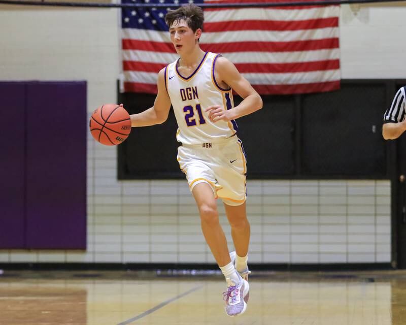 Downers Grove North's Jack Stanton (21) brings the ball up court during varsity basketball game between Lyons at Downers Grove North.  Jan 31, 2023.