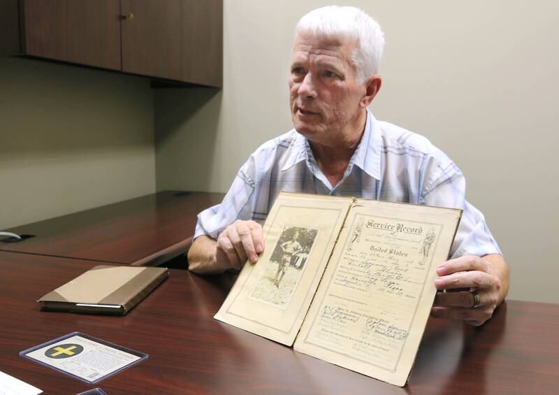 DeKalb resident John Wright talks about a photo of WWI U.S. Army soldier Albert Leonhard Monday, Oct. 7, 2024, that he found in a service record book he purchased at a local estate sale.