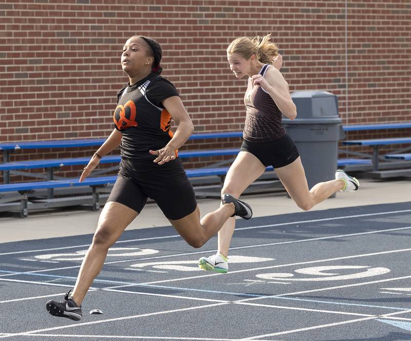 Sycamore’s Alyssa Stacy (right), races Freeport’s Taniah McElroy to the finish in the 100 dash Wednesday, May 14, 2025, during Sectionals at Sterling High School.