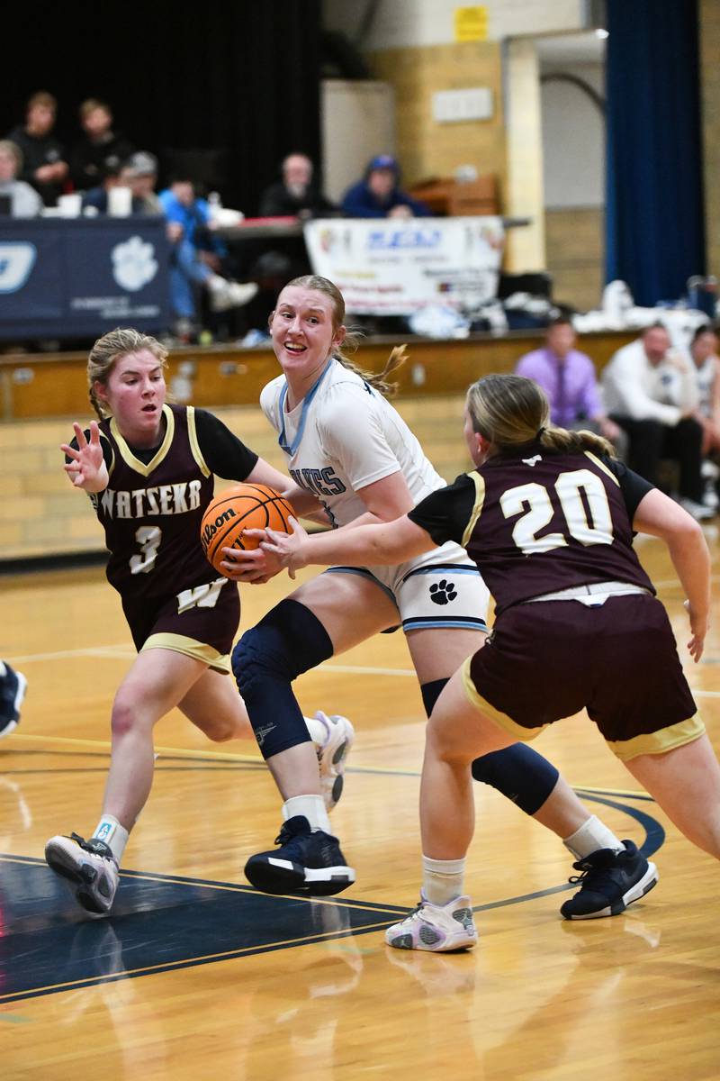 Cissna Park's Addison Lucht looks to pass as she drives the lane against Watseka-Milford's Kyah Westerfield, left, and Noelle Schroeder on Monday, Feb. 10, 2025, during the Timberwolves' 61-40 victory.