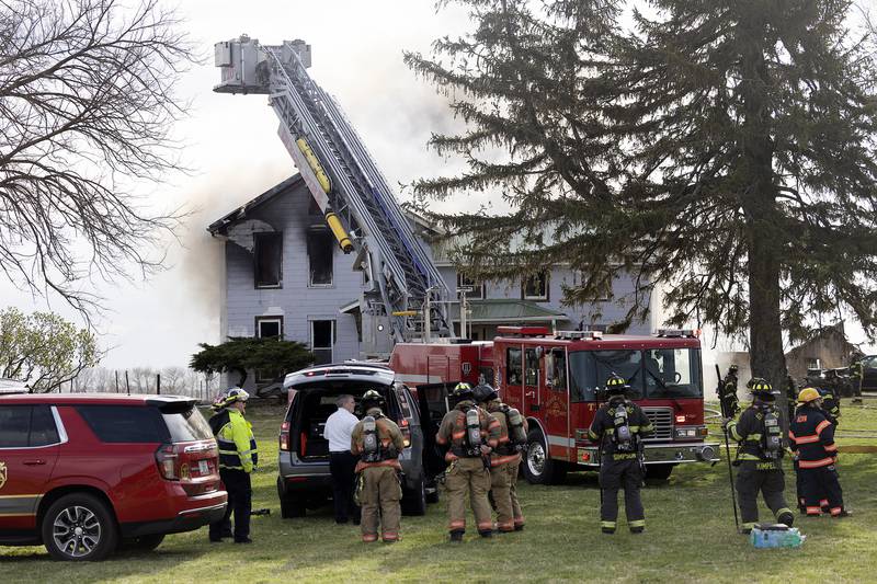 Firefighters battle a house fire Monday, April 14, 2025, at 1308 Harmon Road.