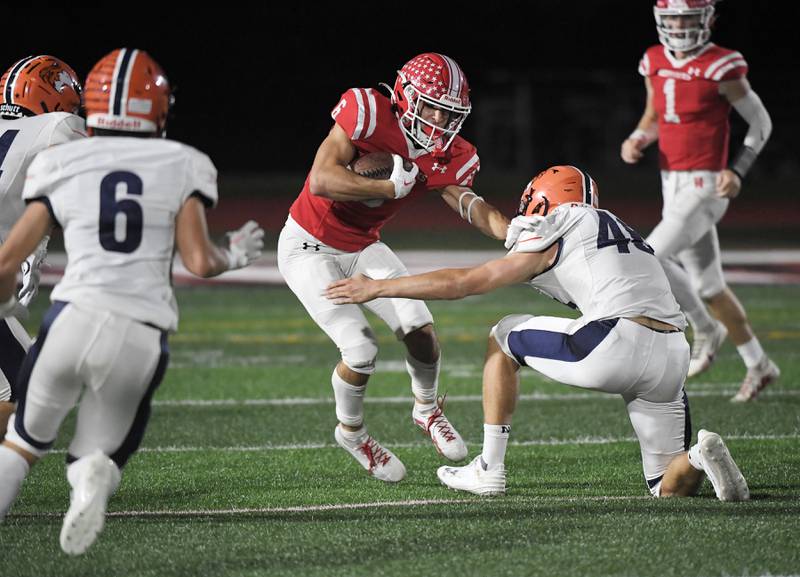 Naperville Central’s Christopher Bern makes a cut against Naperville North’s Matthew Murphy in a high school football game at North Central College in Naperville on Friday, September 29, 2023.
