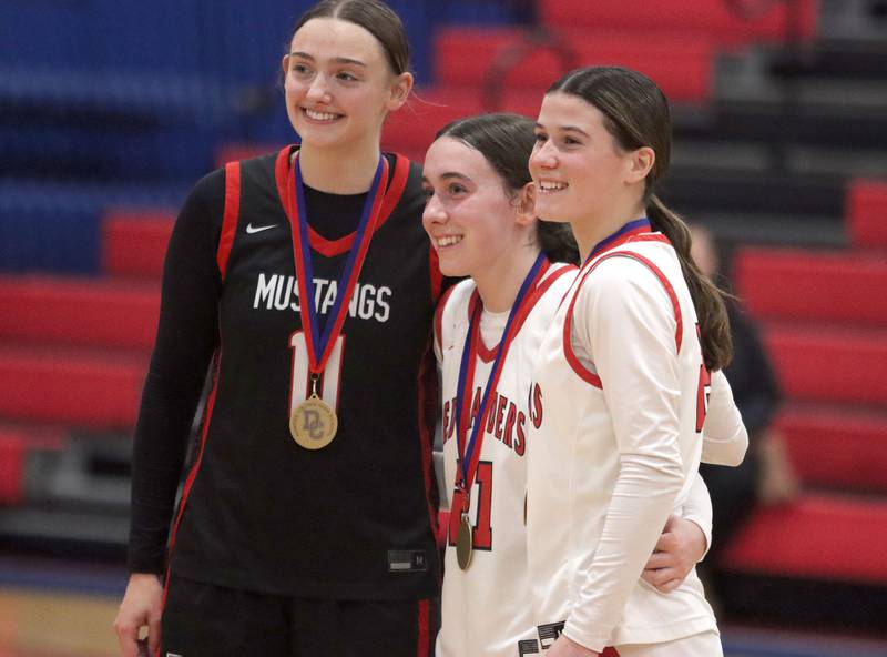 Huntley’s Luca Garlin, center, and Aubrina Adamik, right, along with Mundelein’s Casey Vyverman are recognized as all-tournament team members after varsity girls basketball Komaromy Classic tournament  action on Tuesday, Dec. 30, 2025, at Dundee-Crown High School in Carpentersville.