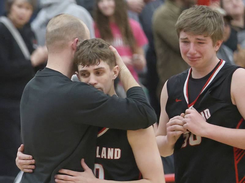 Woodland's Noah Decker hugs head coach Connor Kaminke as teammate Zane Drysdale looks after falling to Indian Creek during the Class 1A Sectional Semifinal game on Wednesday, March 4, 2026 at Amboy High School.