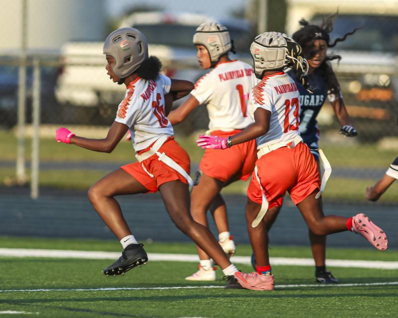 Plainfield East's Kessiah "Siah" Purnell (16) heads to the endzone with her teammates blocking during flag football game between Plainfield East at Plainfield South Wednesday, Sept 10, 2025  in Plainfield.