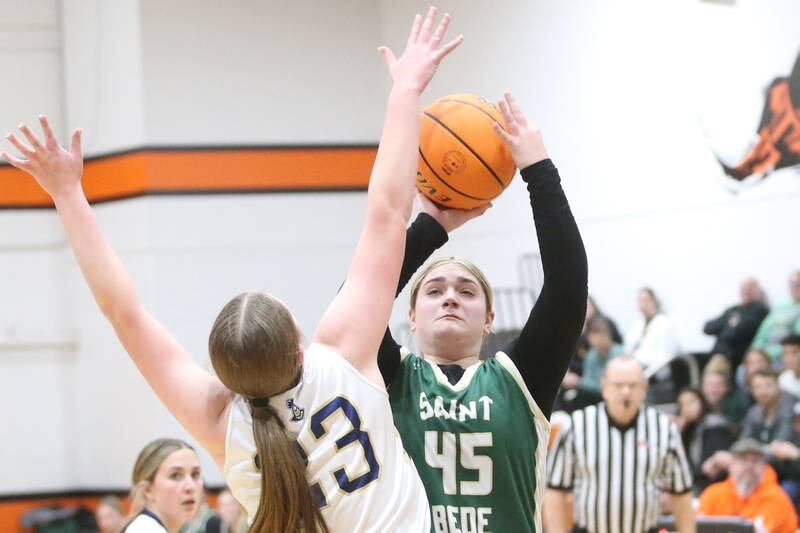 St. Bede's Savannah Bray looks to shoot a jump shot over Marquette's Kelsey Cuchra during the Tri-County Conference championship game on Thursday, Jan. 23, 2025 at Roanoke-Benson High School.