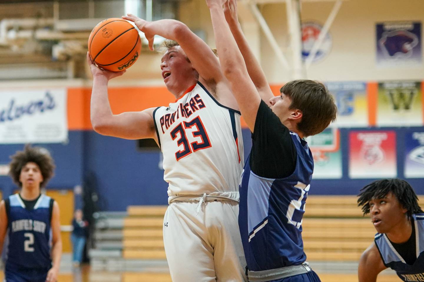 Oswego’s Graham Schwab (33) shoots the ball in the paint against Plainfield South's Brayden Ablin (22) during a basketball game at Oswego High School on Friday, January 17, 2025.
