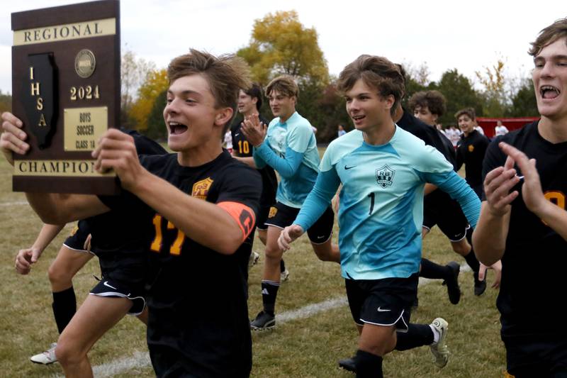 Richmond-Burton's Joseph Kyes and the rest of the ream run to their fans as they celebrate their 3-0 win over Marian Central in the IHSA Class 1A Marian Central Regional Boys Soccer Final match on Tuesday, Oct. 22, 2024, at Marian Central High School in Woodstock.