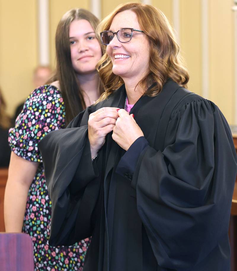 Judge Jill K. Konen is presented with her robe by daughter Amelia after being sworn in as an associate judge of the 23rd Judicial Circuit Friday, Sept. 23, 2022, at the DeKalb County Courthouse in Sycamore.