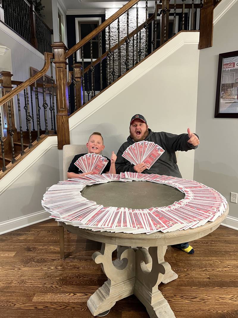 BBQ’d Productions owner Kris Schoenberger and his son, Hunter, show off the envelopes being distributed to dine-in customers during the eighth annual red-envelope campaign. Each envelope contains a prize, with this year’s total prize outlay valued at $150,000.