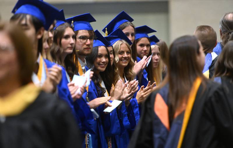Wheaton North graduates applaud the teachers as they enter during the commencement ceremony on Saturday, May 24, 2025 at College of DuPage in Glen Ellyn.