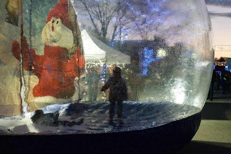 A snowglobe-style bounce house was provided for children during the Christmas Walk in downtown Oswego Dec. 3.