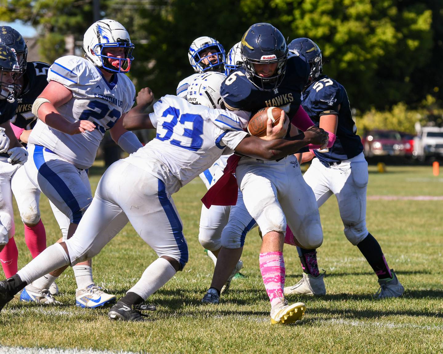 Hiawatha's Aiden Cooper (6) runs the ball while being defended by Rockford Christian Life Fred Swain during the game on Saturday Oct. 11, 2025, held at Hiawatha High School.