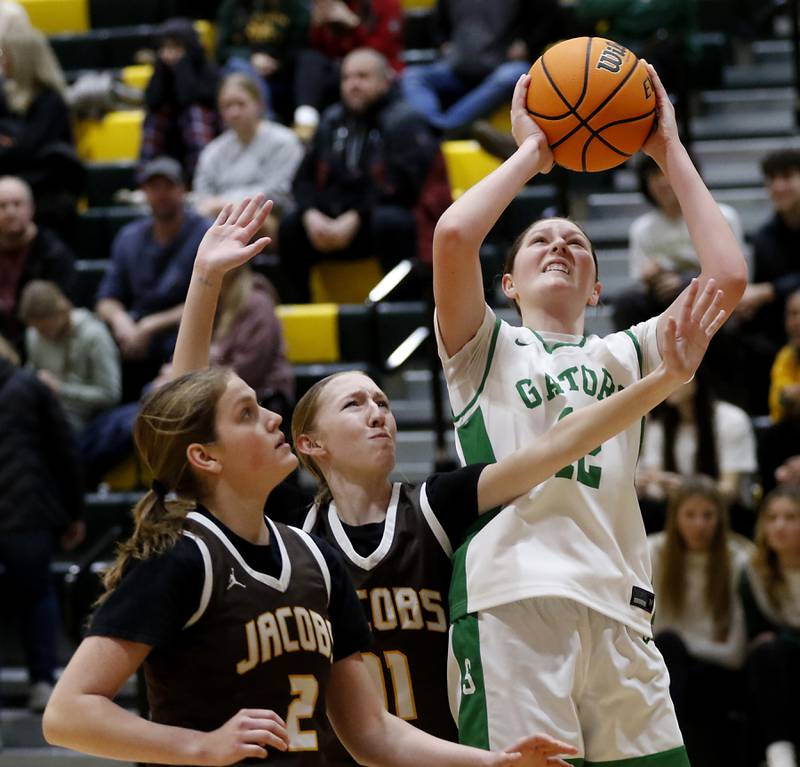 Crystal Lake South's Gaby Dzik (right) shoots the ball over Jacobs' Sarina Acheatel (left)  and Mallory Fessler (center) and during a Fox Valley Conference basketball game on Friday, Jan. 17, 2025, at Crystal Lake South High School.