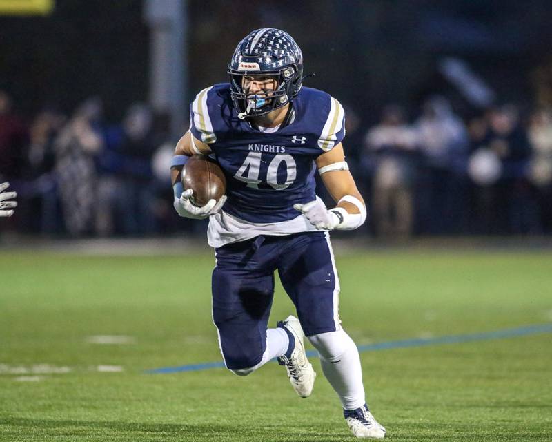 IC Catholic Prep's Dominik Hulak (40) runs with the ball during Class 4A third round playoff football game between St Laurence at IC Catholic Prep.  Nov 11, 2023.