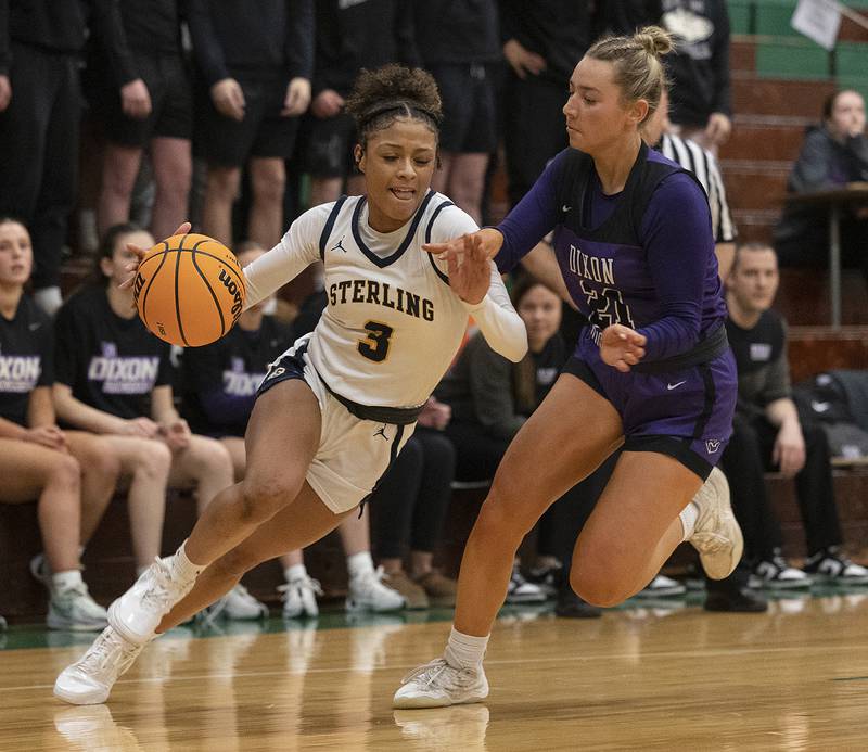 Sterling’s Delali Amankwa drives past Dixon's Reese Dambman Thursday, Feb. 27, 2025, during the Class 3A girls Sectional title at Rockford Boylan High School.