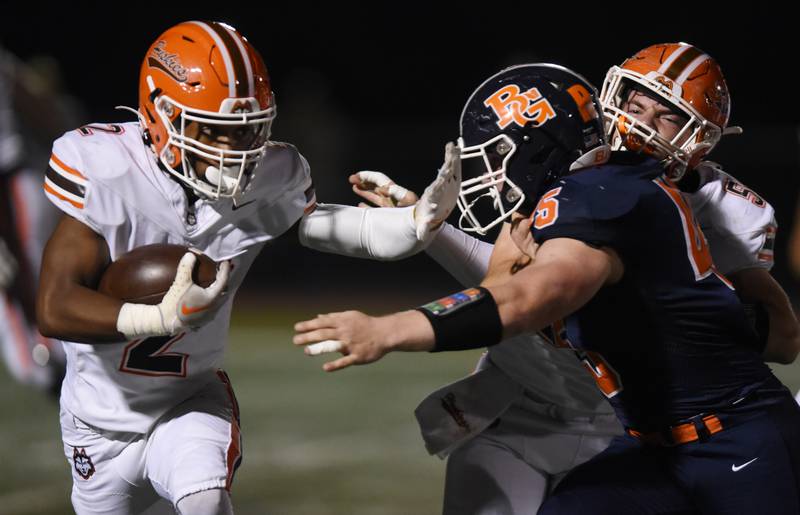 Joe Lewnard/jlewnard@dailyherald.com
Hersey’s Nasir Mckenzie, left, is met by Buffalo Grove’s Caden Watson on a punt return during Friday’s game in Buffalo Grove.